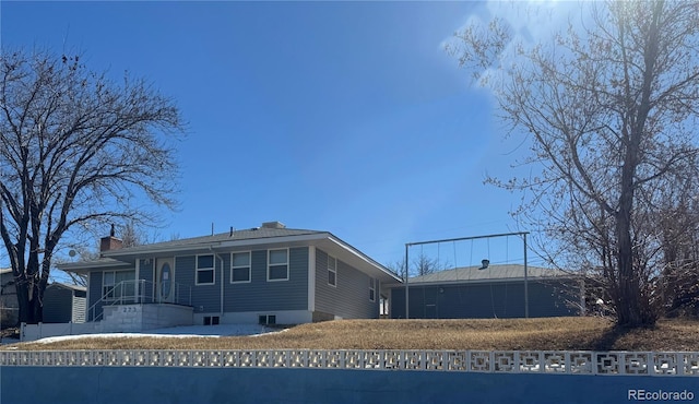 back of property featuring a chimney