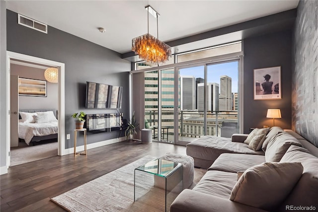 2001 Lincoln St Unit 920, Denver, CO 80202 - living area featuring visible vents, baseboards, wood finished floors, and a chandelier
