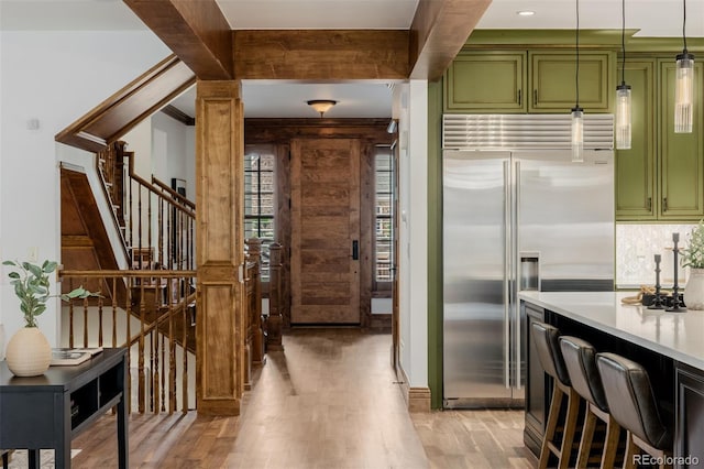 1332 S Lafayette St, Denver, CO 80210 - kitchen featuring green cabinetry, stainless steel built in refrigerator, light wood-style floors, and light countertops