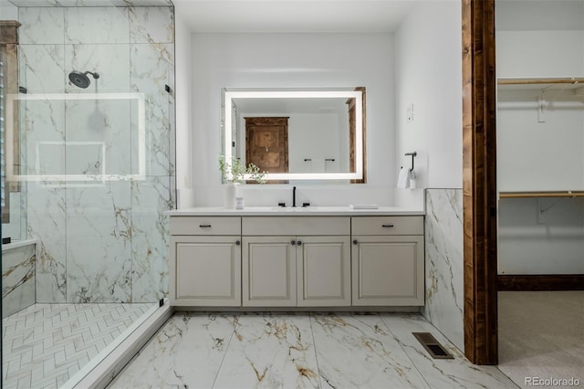 1332 S Lafayette St, Denver, CO 80210 - full bathroom with a marble finish shower, vanity, a walk in closet, and marble look tiles