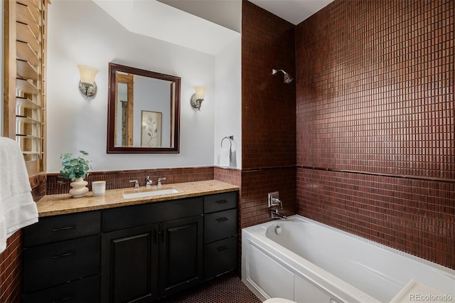 1332 S Lafayette St, Denver, CO 80210 - bathroom with vanity, bathtub / shower combination, and tile walls