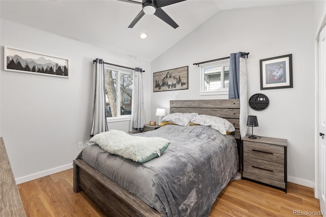 bedroom featuring ceiling fan, lofted ceiling, light hardwood / wood-style floors, and multiple windows