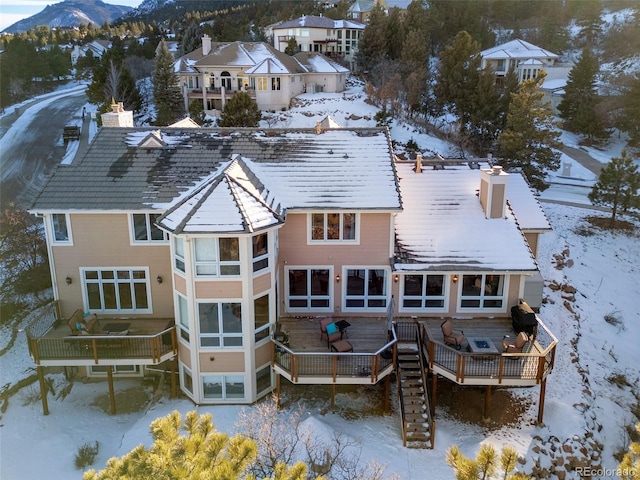 snowy aerial view featuring a mountain view