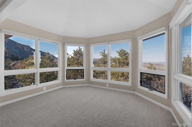 unfurnished sunroom featuring a mountain view