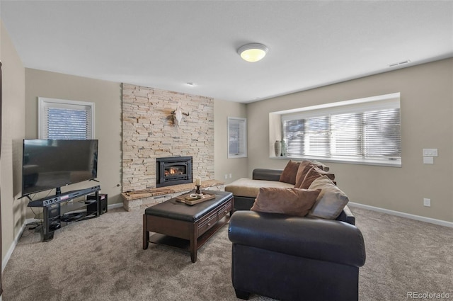 carpeted living room featuring a fireplace