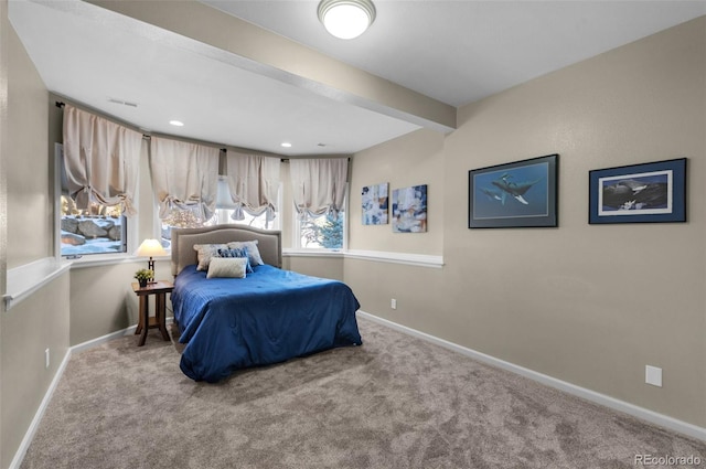 bedroom with light carpet and beam ceiling