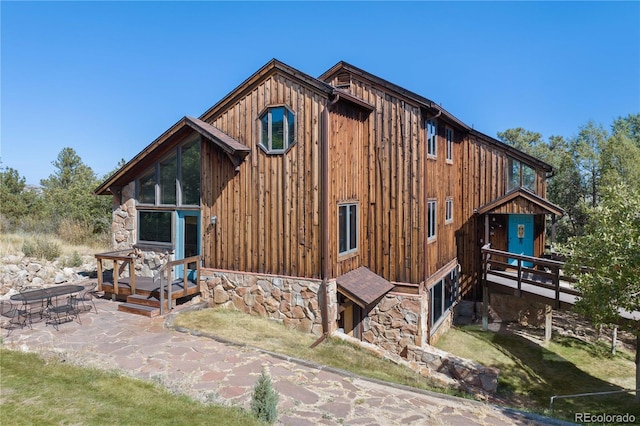 back of house featuring a yard and a patio area