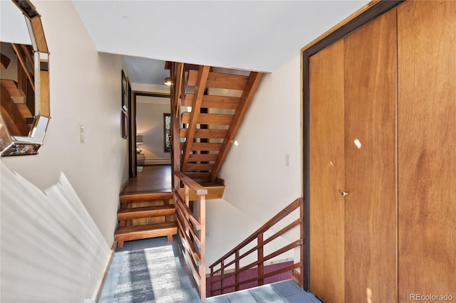 staircase featuring tile patterned floors