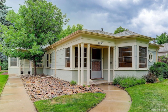 entrance to property with a lawn