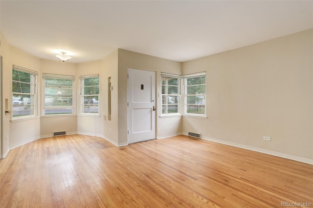 unfurnished room featuring light wood-type flooring