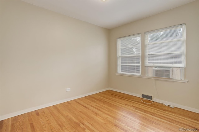 unfurnished room featuring hardwood / wood-style flooring and cooling unit