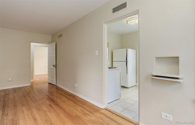 interior space with washer / clothes dryer and light wood-type flooring