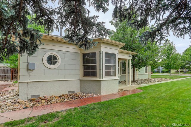 view of side of home with a lawn