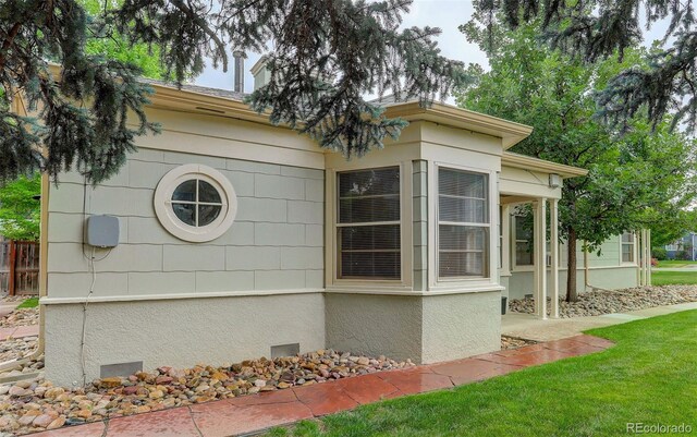 view of side of home featuring a yard