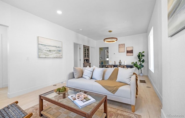 2207 E 25th, Denver, CO 80205 - living room featuring light wood finished floors and baseboards