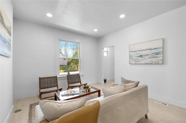 2207 E 25th, Denver, CO 80205 - living area featuring light wood-style floors, recessed lighting, and baseboards