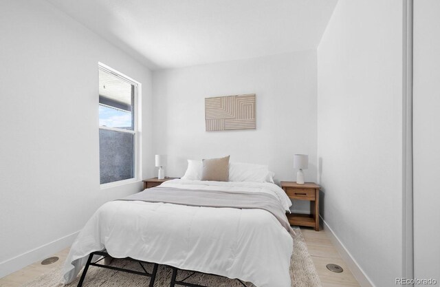 2207 E 25th, Denver, CO 80205 - bedroom with baseboards and light wood finished floors