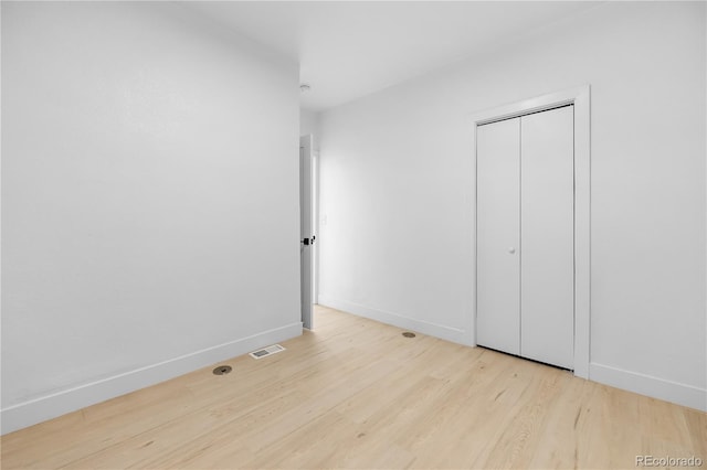 2207 E 25th, Denver, CO 80205 - unfurnished bedroom featuring wood finished floors, baseboards, and a closet