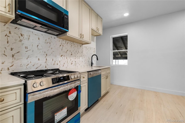 2207 E 25th, Denver, CO 80205 - kitchen with gas stove, black microwave, dishwasher, light wood finished floors, and decorative backsplash