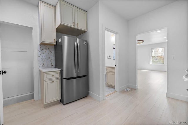 2207 E 25th, Denver, CO 80205 - kitchen with freestanding refrigerator, backsplash, light wood-type flooring, and baseboards