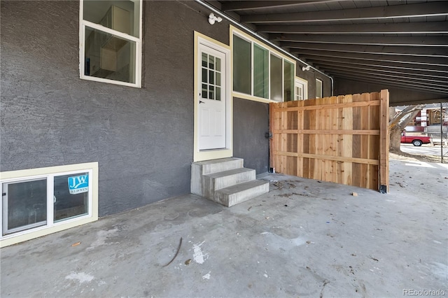 2207 E 25th, Denver, CO 80205 - doorway to property featuring stucco siding and fence