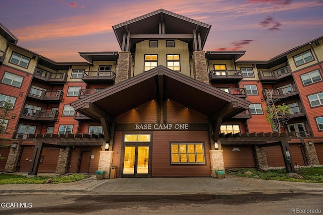 view of outdoor building at dusk