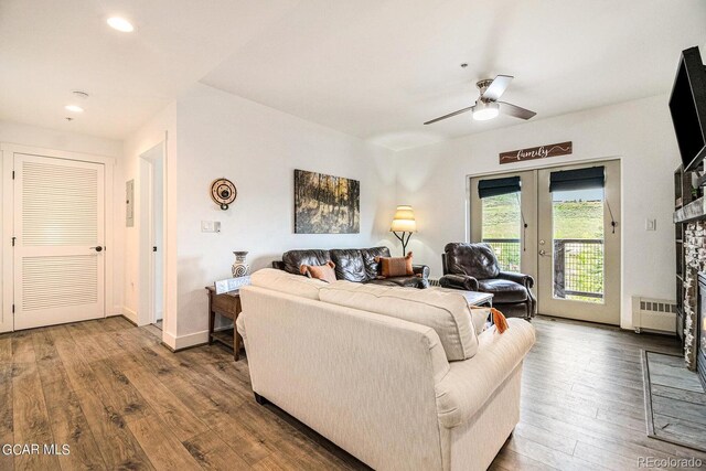 living room featuring ceiling fan, french doors, and hardwood / wood-style floors