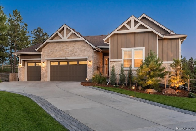 craftsman house with a garage and a front lawn