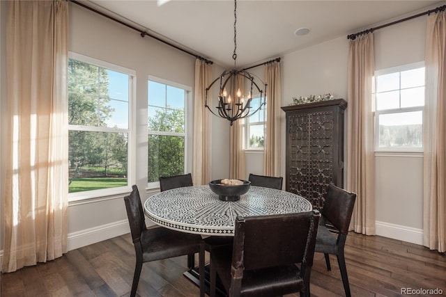 dining area with an inviting chandelier and dark wood-type flooring