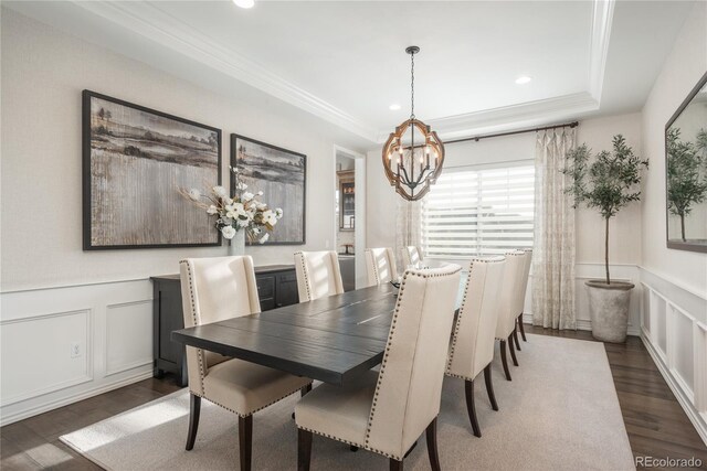 dining space with crown molding, dark hardwood / wood-style floors, and a chandelier