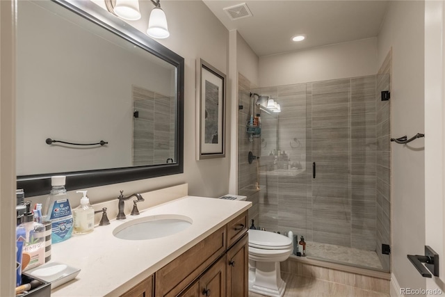 bathroom featuring walk in shower, vanity, and toilet