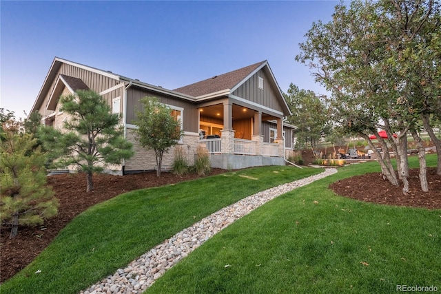 view of side of property with a lawn