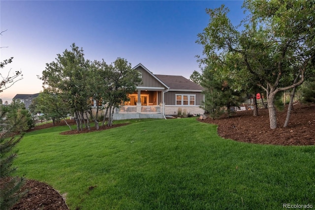 back house at dusk with a yard