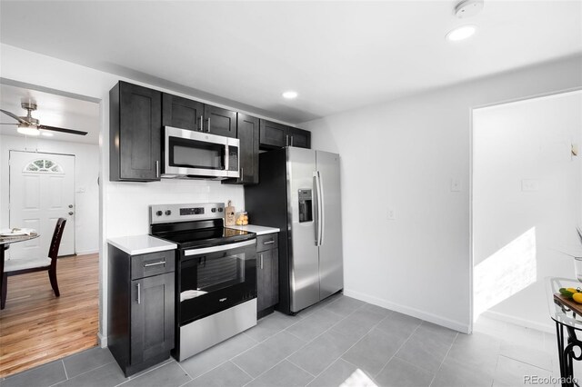 1148 N Clinton St, Aurora, CO 80010 - kitchen featuring appliances with stainless steel finishes, light countertops, dark cabinets, baseboards, and recessed lighting