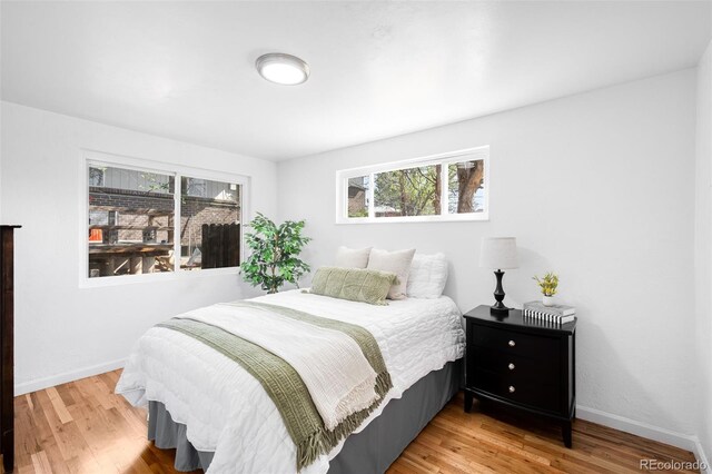 1148 N Clinton St, Aurora, CO 80010 - bedroom featuring light wood finished floors and baseboards