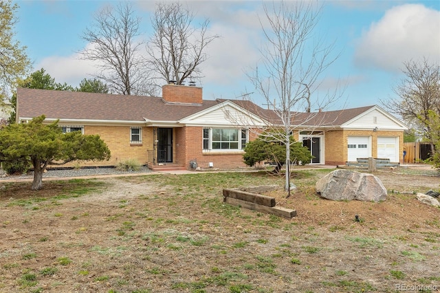 1345 Laredo St, Aurora, CO 80011 - ranch-style house featuring an attached garage, brick siding, and a chimney
