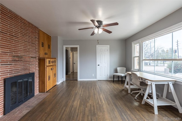 1345 Laredo St, Aurora, CO 80011 - office with baseboards, a brick fireplace, ceiling fan, and dark wood-type flooring