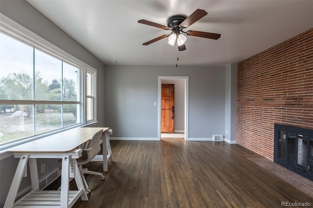 1345 Laredo St, Aurora, CO 80011 - interior space featuring wood finished floors, a brick fireplace, visible vents, baseboards, and ceiling fan