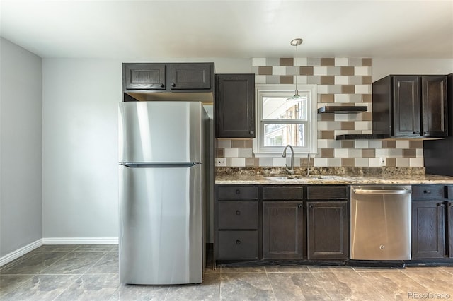 1345 Laredo St, Aurora, CO 80011 - kitchen with light stone countertops, baseboards, dark brown cabinets, a sink, and appliances with stainless steel finishes
