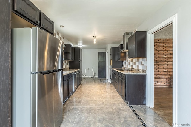 1345 Laredo St, Aurora, CO 80011 - kitchen featuring brick wall, stainless steel appliances, light stone countertops, and wall chimney exhaust hood