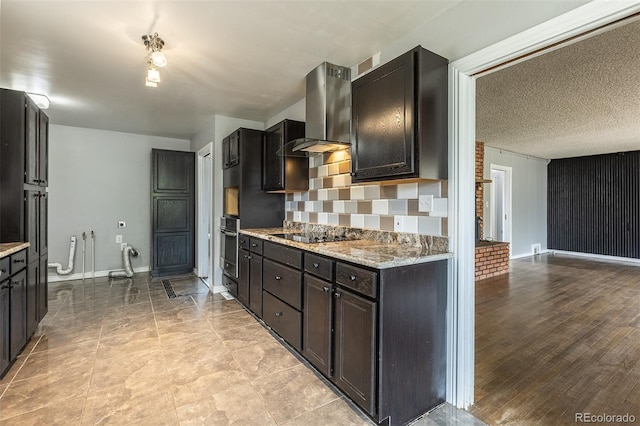 1345 Laredo St, Aurora, CO 80011 - kitchen with stainless steel oven, wall chimney range hood, baseboards, and black electric stovetop