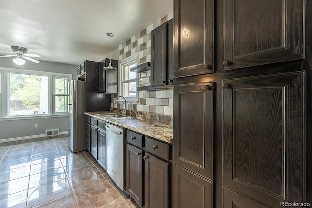 1345 Laredo St, Aurora, CO 80011 - kitchen featuring a sink, stainless steel appliances, visible vents, dark brown cabinetry, and a ceiling fan