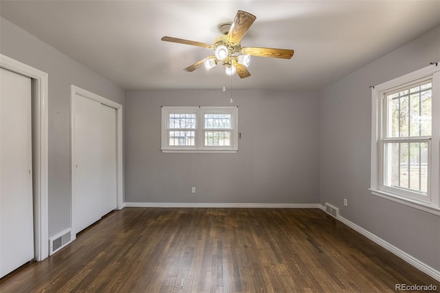 1345 Laredo St, Aurora, CO 80011 - unfurnished bedroom with baseboards, visible vents, and dark wood finished floors