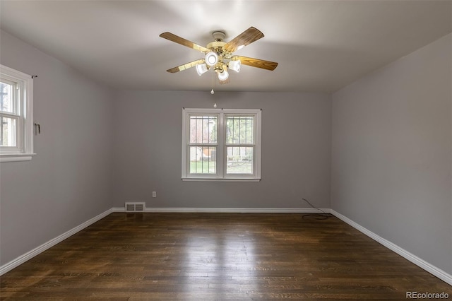 1345 Laredo St, Aurora, CO 80011 - empty room featuring baseboards, visible vents, ceiling fan, and dark wood-type flooring