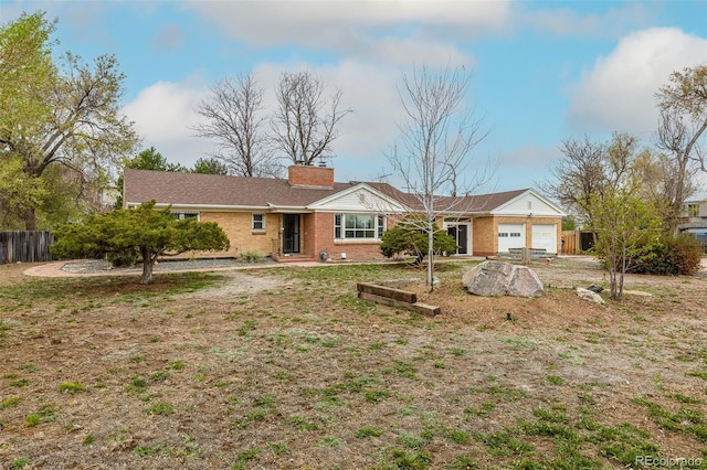 1345 Laredo St, Aurora, CO 80011 - single story home featuring fence, a garage, a chimney, and brick siding