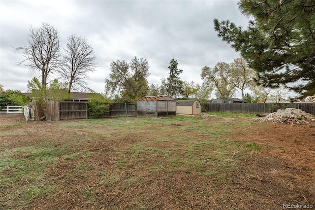 1345 Laredo St, Aurora, CO 80011 - view of yard with an outbuilding, a fenced backyard, and a storage unit