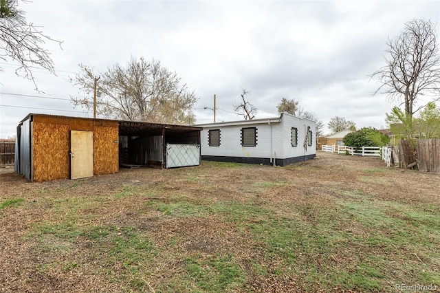 1345 Laredo St, Aurora, CO 80011 - back of property with a pole building, fence, and an outbuilding