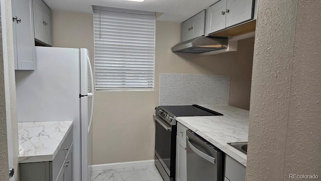kitchen featuring marble finish floor, electric stove, freestanding refrigerator, baseboards, and stainless steel dishwasher