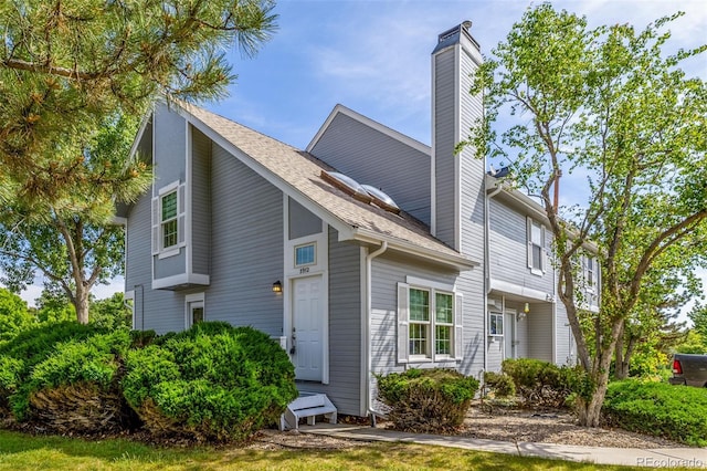3912 S Richfield Way, Aurora, CO 80013 - view of home's exterior with a chimney and roof with shingles