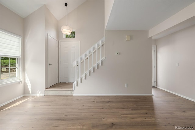 3912 S Richfield Way, Aurora, CO 80013 - entryway featuring stairs, wood finished floors, baseboards, and high vaulted ceiling